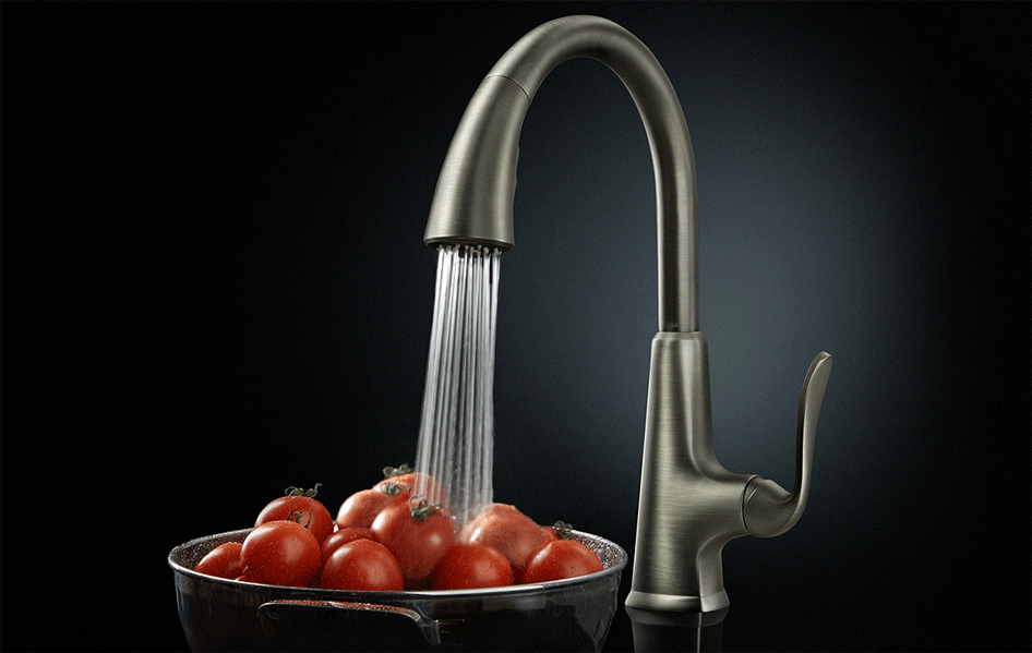 Slate faucet with water running over bowl of tomatoes
